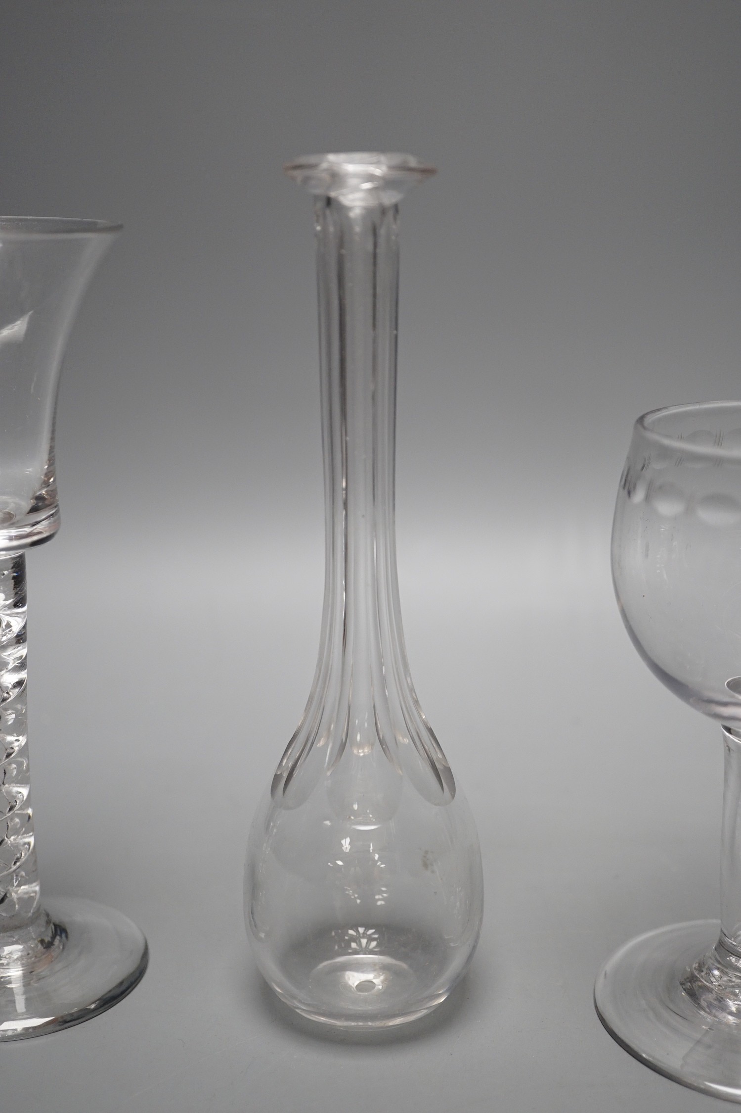 A George II mercury twist stem glass, a George III hollow stem glass, a toddy lifter and an air twist glass, tallest 17cm (4)